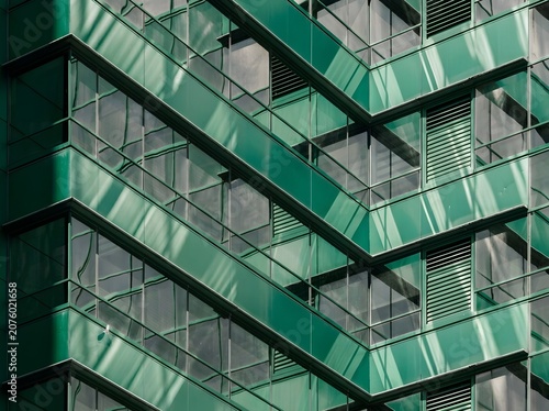 Emerald Green Modern Apartment Facade, Repeating Zigzag Balconies with Reflective Glass Panels and Metal Frames Creating Dynamic Geometric Pattern, Contemporary Urban Architecture Detail Ideal for Rea