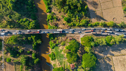 Tableau sur toile Surrounded by agricultural fields and lush green forest, the accident scene highlights the importance of this key river crossing route connecting local communities