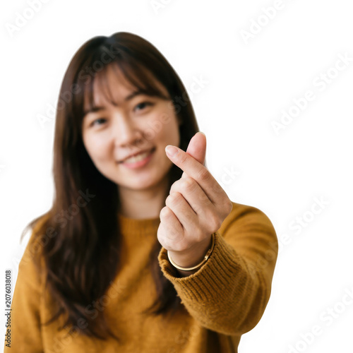 Young Asian Woman Making Heart Gesture with Fingers.