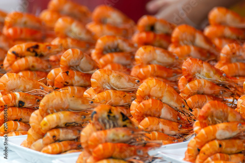 Принти на полотні Fresh grilled shrimp arranged for sale at local seafood market showcasing delici