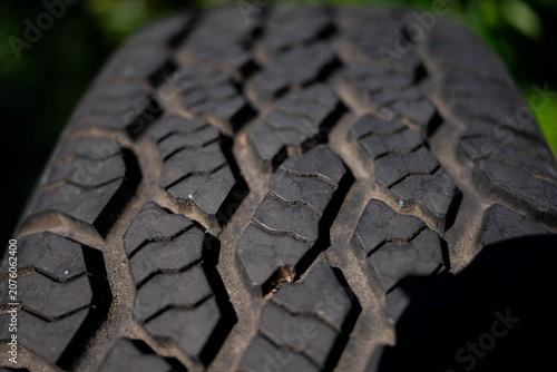 Used , worned off road tyre close up shot at natural light.