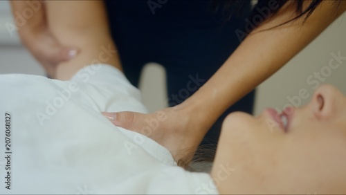 Bild auf Leinwand Close-up of a woman receiving a relaxing and therapeutic shoulder massage in a c