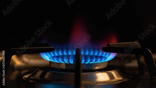 Gas Burner Ignition with Blue Flame on Kitchen Stove. 4K Video