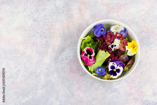 Spring garden salad with edible flowers and mixed lettuce
