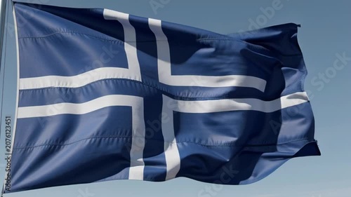 Waving Flag of Iceland Against a Clear Blue Sky.