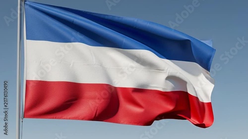 Waving Flag of the Republic of Yugoslavia Against a Clear Blue Sky.