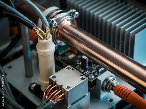 Closeup of metal tube with wires and circuit board components connected together