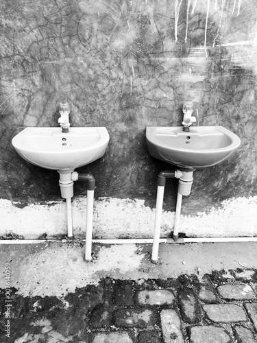 Selective focus. Ceramic wall-mounted washbasin. Black. White.
