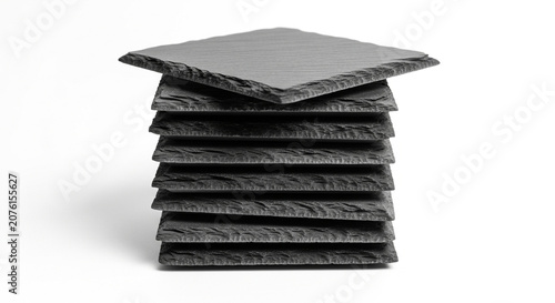 Stack of black slate plates on white background
