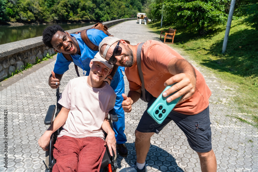 Fototapeta premium Diverse friends capturing joyful outdoor selfie on lakeside path