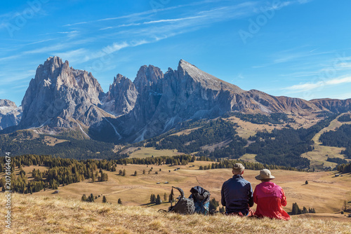 Hikers enjoying panoramic view of Seceda mountain range in the Dolomites, Italy