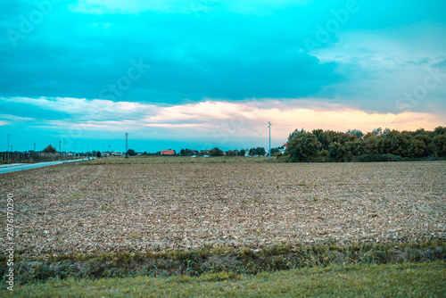 Foto Rural landscape with harvested field under twilight sky