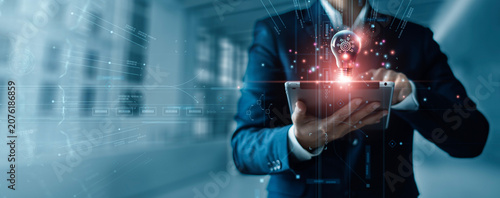 Innovation and technology business concept, Ai, Algorithm, Dynamic Business Solutions, Creativity and inspiration of business, Businessman holding tablet and light bulb with digital data network.