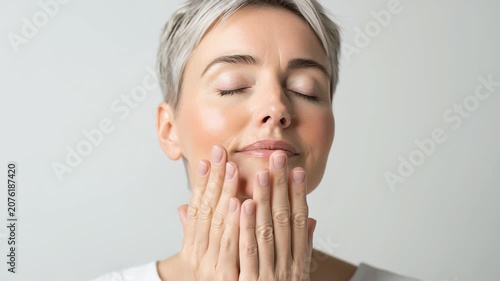 Radiant middle-aged woman embracing natural beauty with gray hair and serene expression