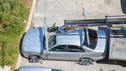 Car Transporter Loading a Silver Sedan on Vehicle Carrier Truck