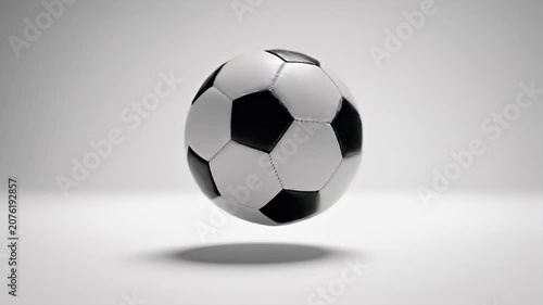 3D illustration of a classic black and white soccer ball floating in a minimalist studio background with soft shadow