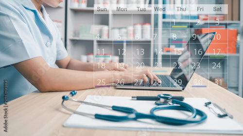 Medical staff with virtual digital calendar on laptop to plan patient treatment and follow up in hospital. Appointment scheduler agenda calendar organizer planner time management concept.