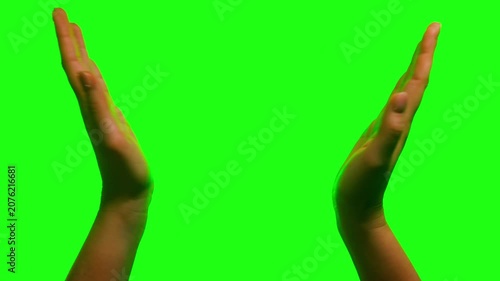 Close-up of hands clapping on green screen background. Applause gesture isolated on chroma key for editing and compositing. High quality 4k footage