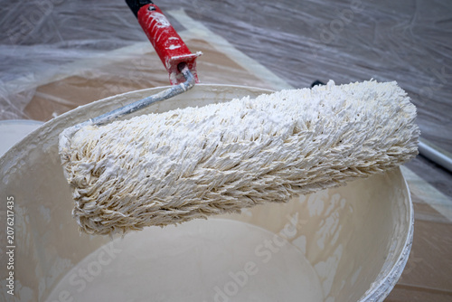Tableau sur toile Roller and paint bucket in a room during a renovation project on a weekday