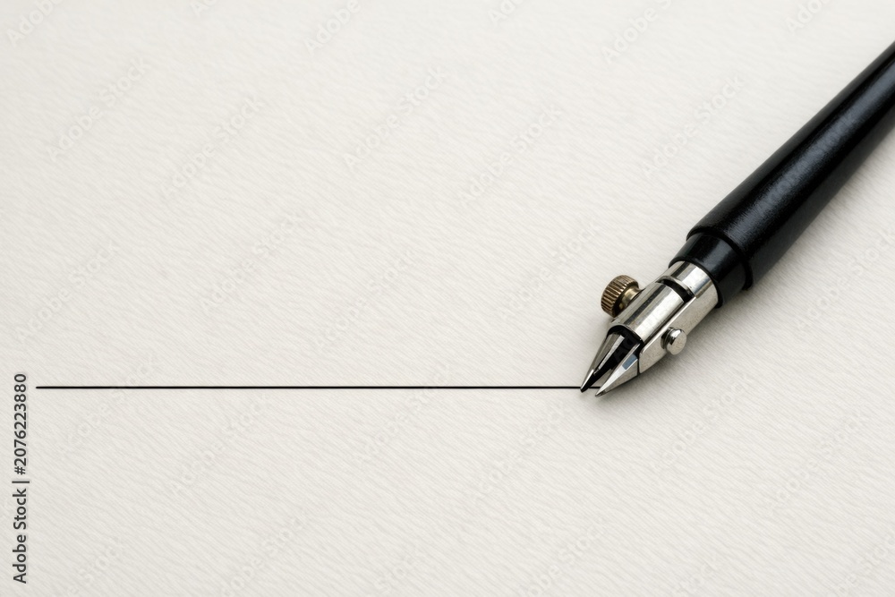 Fototapeta premium A pen sits atop a blank piece of paper, ready for writing or drawing