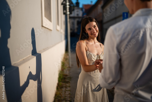 Obraz na plátně Happy couple interacting on an old city street