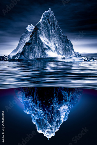 massive iceberg with vast underwater section in arctic ocean, enormous iceberg floating in cold polar waters, arctic iceberg revealing hidden underwater mass in deep blue sea