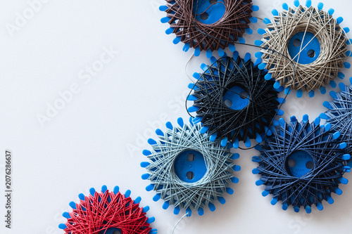 Photography six spools of sewing thread and darning thread in different designs and colors
