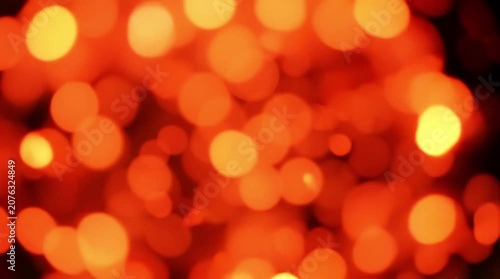Abstract Background with Glowing Orange and Red Bokeh Lights Created by Blurred Bright Circles in Varying Sizes