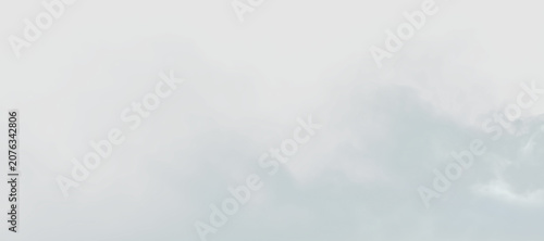 Bild auf Leinwand Clouds drift in the sky during the day creating a soft, light atmosphere over a