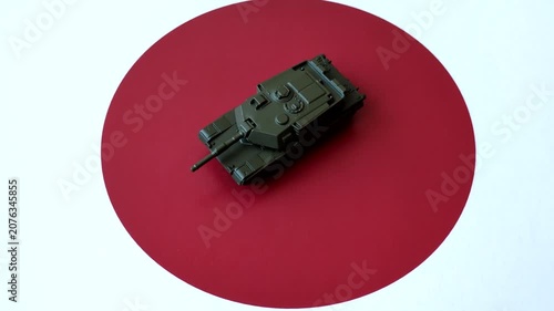 A tank on the Japanese flag as a conceptual backdrop representing defense and preparation against attack. A tank on the Japanese flag as a background for your design