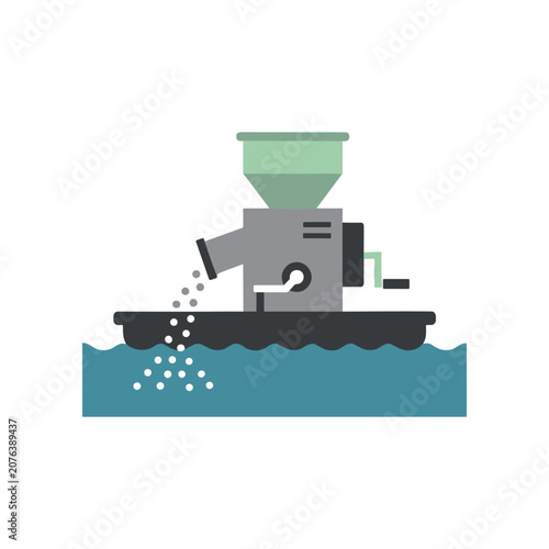 Foto Industrial machine dispensing feed pellets.