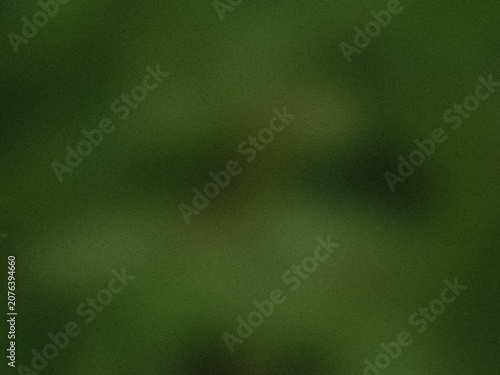 Abstract blurred background with soft dark green tones and grainy texture.