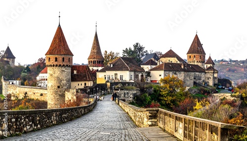 Historic European town with Gothic cathedral and autumn foliage.