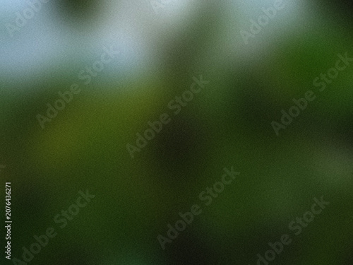 Abstract background with soft blurred green and dark tones for design.