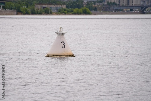  River navigation buoy in the water in summer.                              