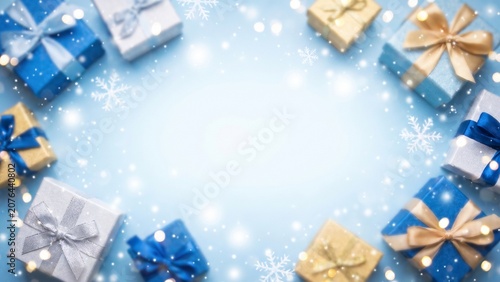 Festive Christmas Gift Boxes Border with Snowflakes and Bokeh Lights on Blue Background