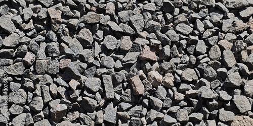 Fotografija Crushed stone creating a textured surface, ideal for backgrounds, construction,