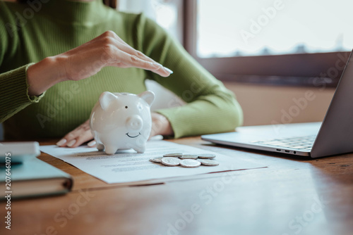 Protecting Savings with Piggy Bank and Hands in Financial Security Concept