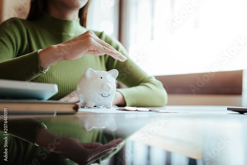 Protecting Savings with Piggy Bank and Hands in Financial Security Concept