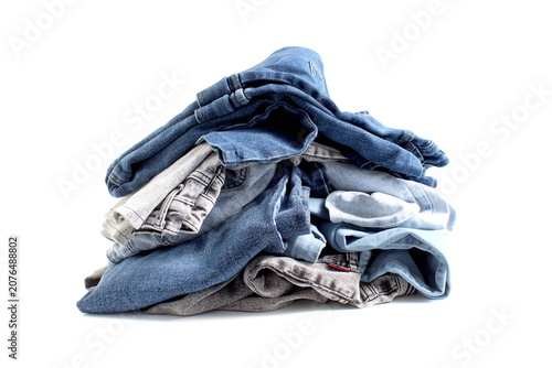 Photos A pile of jeans lies on a white background.