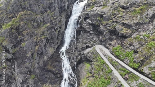 Aerial drone pan up of upper Trollstigen visitor centre and Stigfossbrua, Norway