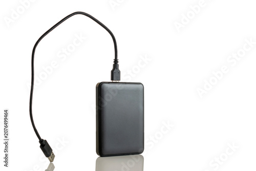 Fotografija Black external hard drive disk (HDD) with USB cable connected, isolated on a white background with reflection