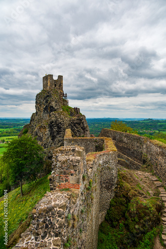 Iconic towers of Trosky Castle Ruins rising on ancient volcanic rock formations beneath dramatic stormy skies in the beautiful Bohemian Paradise, Czech Republic.