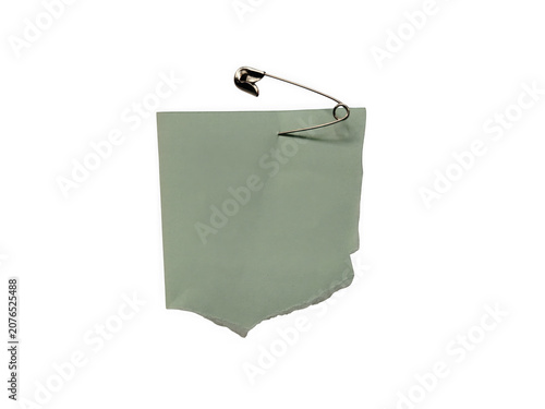 Fotografie A green fabric pocket with a metal safety pin attached to the top edge detail is