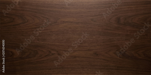 Reddish mahogany walnut wood texture background with soft center highlight and warm abstract grain surface for elegant table backdrop