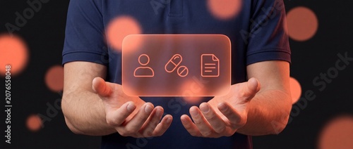 A man holds a glowing digital interface featuring icons of a patient medication and medical documentation symbolizing modern healthcare