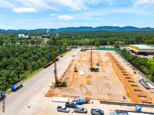 Canvas Print Aerial view of cranes and pile drivers at work on a construction site, driving piles for industrial plants and large buildings