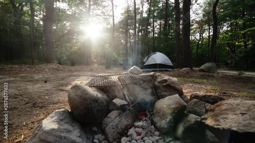 Calm cracking coals at designated outdoors camping background spot ready for a grill