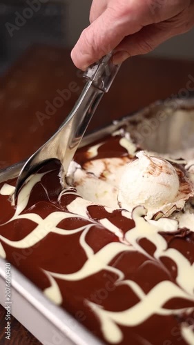 Supermarket ice cream shelf with various flavors and brands, retail food concept.