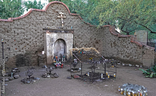 The local shrine of El Tiradito, the little lost one, in the old barrio of Tucson, Arizona where community members mourn otherwise forgotten people with candles, flowers and messages put into the wall